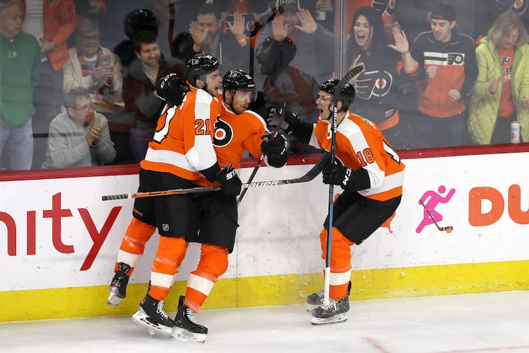 Flyers forward Michael Raffl (center) celebrates his goal with Scott Laughton (21) and Tyler Pitlick during the second period Thursday night.