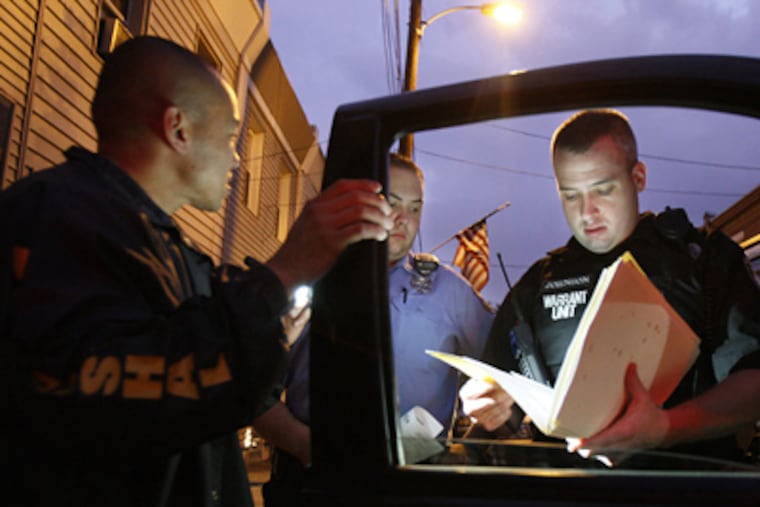 Operation Pressure Point, a Phila. police-led effort to fight violence by targeting the most troubled neighborhoods at the most dangerous times, had (from left) U.S. Marshal Robert Clark, Officer Chris Hyk, and Warrant Unit Investigator Bill Johnson working together June 26. (Elizabeth Robertson / Staff Photographer)
