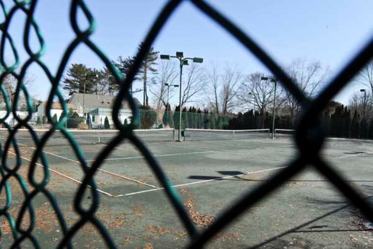 The unkept tennis courts of the Woodcrest Country Club at 300 E Evesham Rd in Cherry Hill, is locked behind chain link fence. The club said Friday it would not open this season and that a sale is imminent. (RON TARVER /