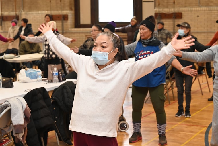 Mai Ngoc Nguyen, a volunteer, practices qigong during a recent Elders Council meeting at SEAMAAC.