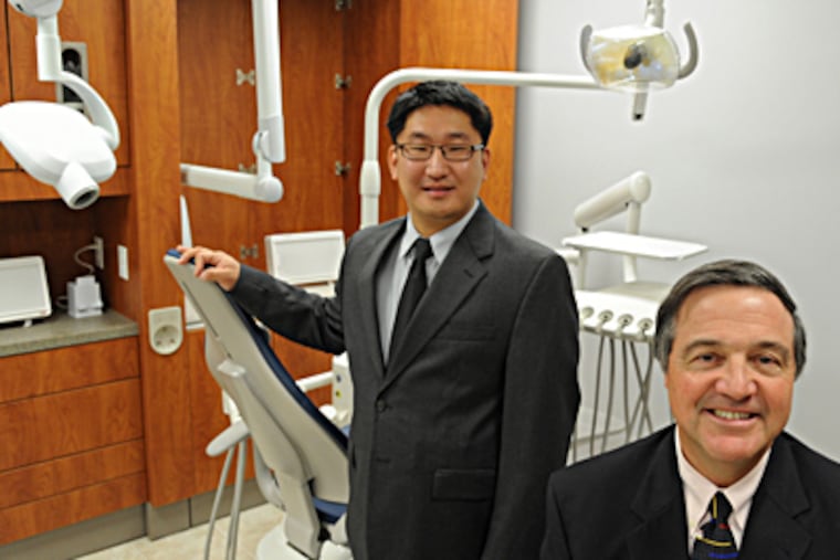Wayne dentist Ken Fetter (right) and Andrew Lee, director of World Impact Chester, at the Grace Dental Clinic. CLEM MURRAY / Staff Photographer