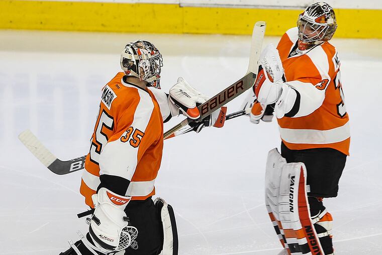 Flyers goalie Steve Mason (left) and Michal Neuvirth.