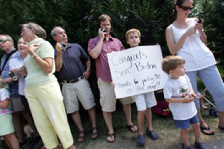 Michael Hutts, 8, holds a sign of congratulations as he and his family wait to greet Biden outside the senator's house. "It'sbig news for Delaware," said Michael's mother, Beth (right).