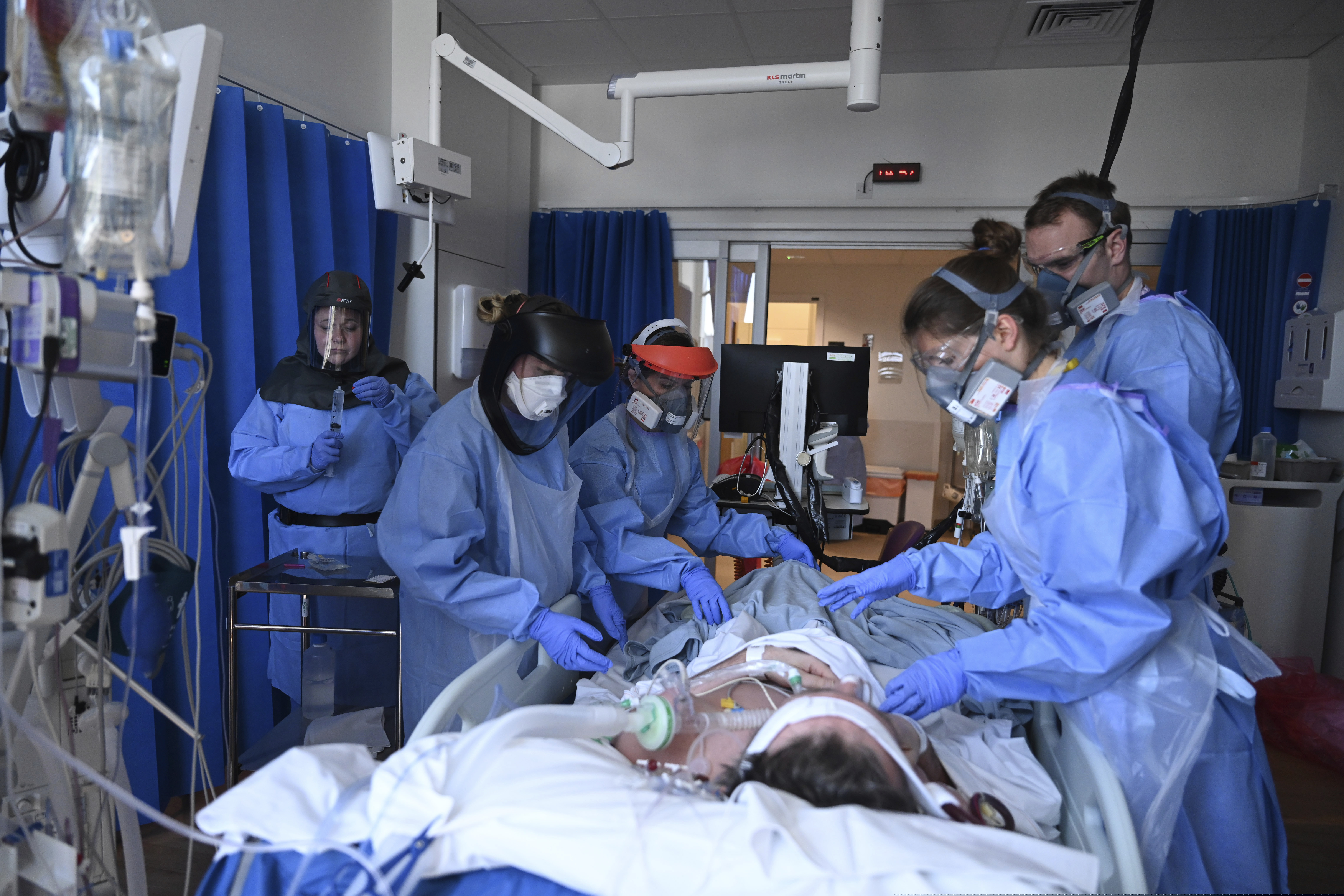 Members of the clinical staff wearing Personal Protective Equipment PPE care for a patient with coronavirus in the intensive care unit at the Royal Papworth Hospital in Cambridge, England.