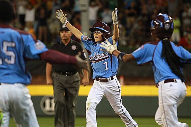 Taney's Tai Shanahan runs to celebrate with his teammates. (Michael Bryant/Staff Photographer)