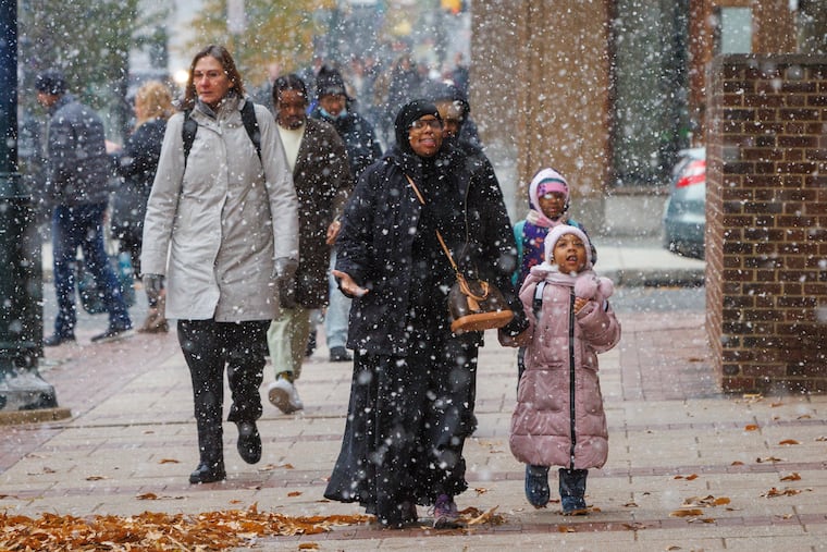 Snow falls over Market Street in Center City last week. Another "trace" was recorded Wednesday.