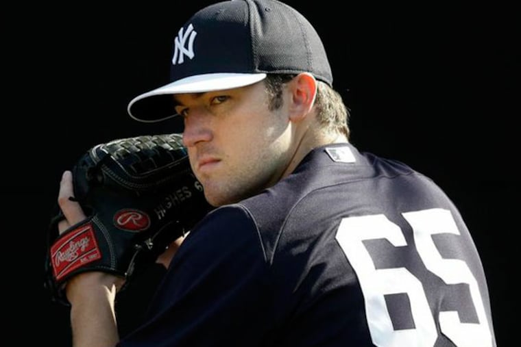 New York Yankees' Phil Hughes pitches during a workout at baseball
spring training, Saturday, Feb. 16, 2013, in Tampa, Fla. (Matt Slocum/AP)
