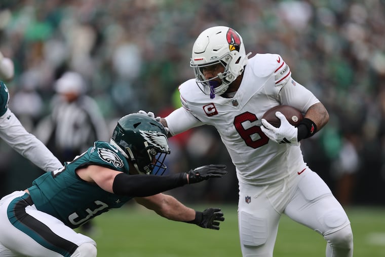 Arizona Cardinals running back James Conner stiff-arms Eagles safety Reed Blankenship in the first quarter Sunday.