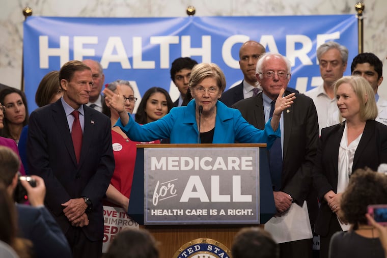 US Senator Elizabeth Warren (C), Democrat from Massachusetts, speaks with US Senator Bernie Sanders (2nd R), Independent from Vermont, as they discusses Medicare for All legislation on Capitol Hill in Washington, DC, on September 13, 2017. (Jim Watson/AFP via Getty Images)
