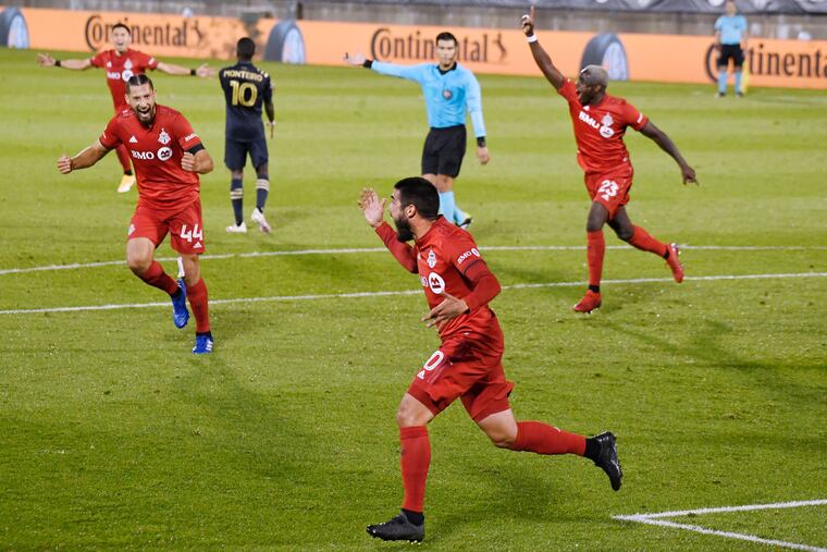 Alejandro Pozuelo, center, celebrates his game-winning goal for Toronto FC.