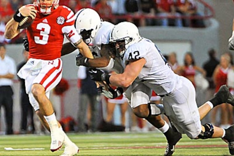 Nebraska's Taylor Martinez tries to get away from Penn State's
Gerald Hodges and Michael Mauti. (Dave Weaver/AP)