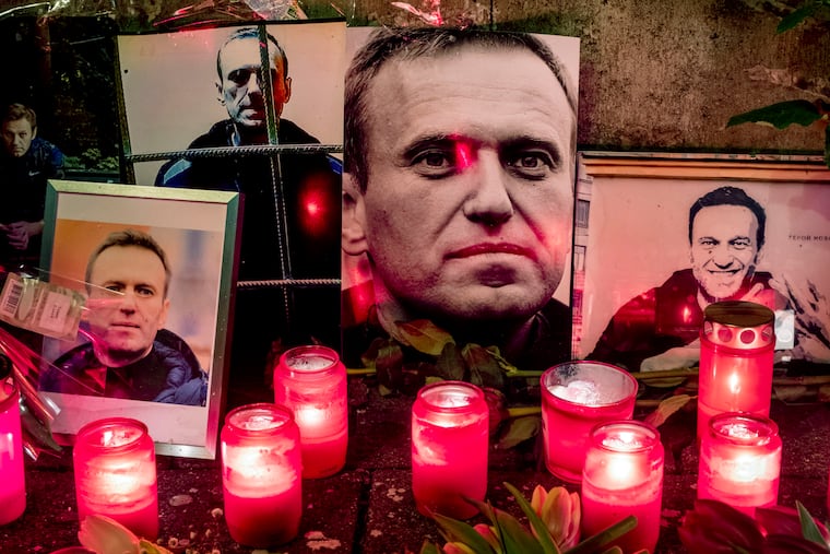 Candles and photos of Russian opposition leader Alexei Navalny are placed near the Russian Consulate in Frankfurt, Germany, on Saturday. Navalny, President Vladimir Putin's fiercest foe, died Friday in an Arctic penal colony.