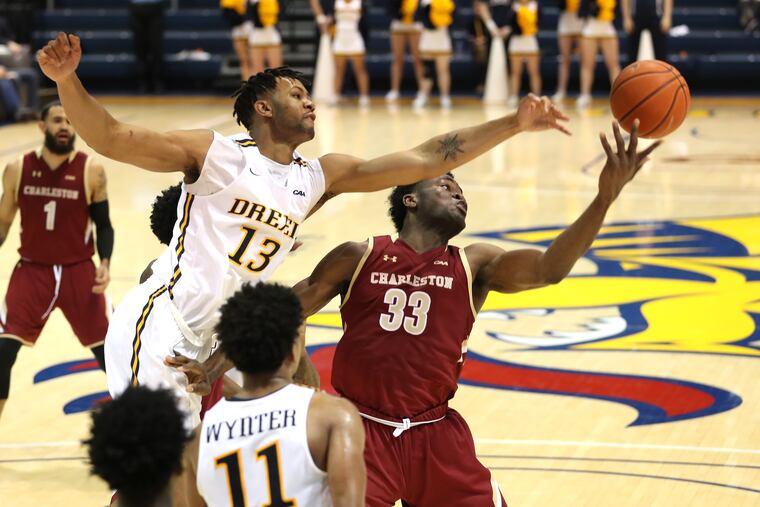 Tim Perry, top left, of Drexel and Osinachi Smart, right, of Charleston go after a rebound during the 2nd half on Dec. 28, 2019.