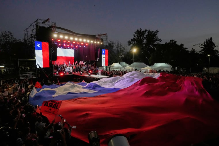 Supporters of presidential candidate Jeannette Jara of the Unidad por Chile coalition attend a rally Wednesday in Santiago ahead of Chile's presidential runoff election.