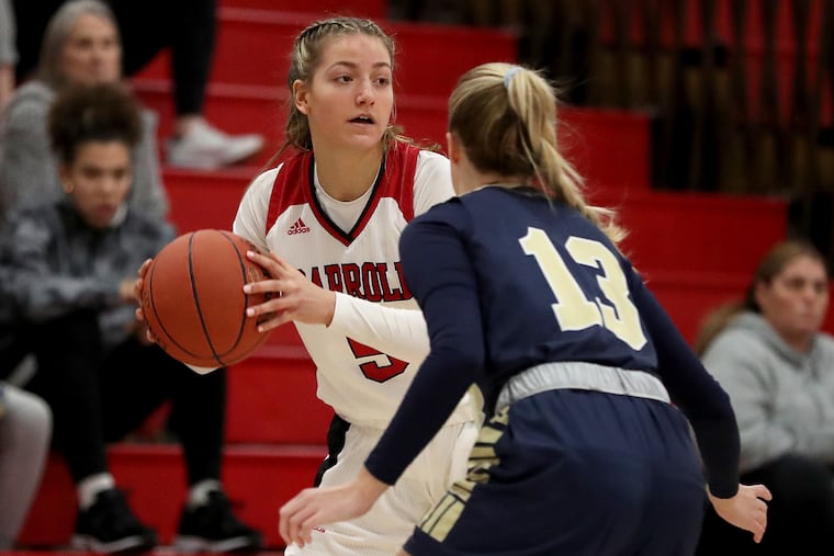 West Chester Rustin’s Elizabeth McGurk (right) covers Archbishop Carroll’s Brooke Wilson at Ursinus College's Helfferich Gym on Jan. 15.