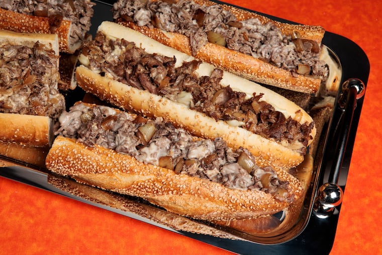 Cheesesteaks from Uncle Gus’ and John’s Roast Pork at the Inquirer studio on Wednesday, March 5, 2025 in Philadelphia. Food styling by Emilie Fosnocht.