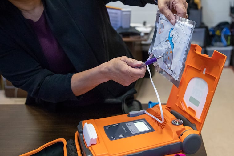 Donna Santos, a school nurse at Benjamin Franklin High School, opening an automated external defibrillator (AED) kit inside the school's main office on Feb. 5, 2019.