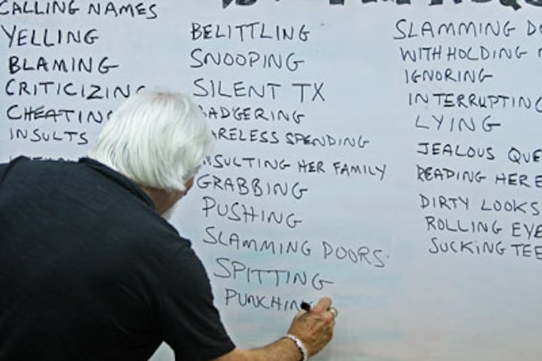 During a group session recently, Paul Bukovec, director of Menergy, wrote down words is clients called as defintions of emotional abuse. (Michael Bryant / Staff Photographer)