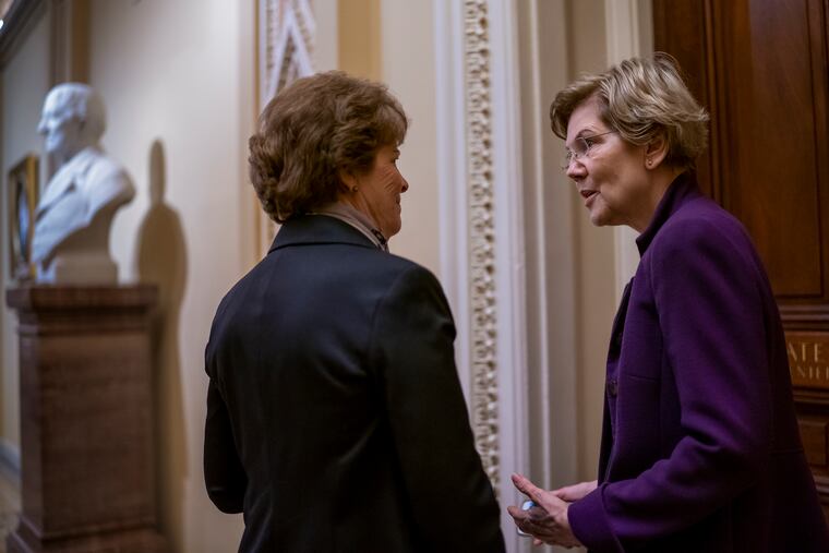 Democratic presidential candidate Sen. Elizabeth Warren, D-Mass., right, confers with Sen. Jeanne Shaheen, D-N.H., during a series of votes on the war powers resolution which asserts that President Donald Trump must seek approval from Congress before engaging in further military action against Iran, on Capitol Hill in Washington, Thursday, Feb. 13, 2020.