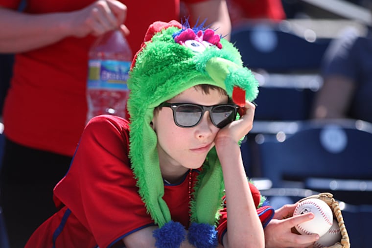 Ben Helfrich, of North Philadelphia, 9, leans on the Phillies dugout roof. (Michael Bryant/Staff Photographer)