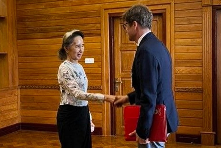 In this photo released by Myanmar President Office on Monday, Aug. 3, 2026, Myanmar's ousted leader Aung San Suu Kyi, left, shakes hands with Arnaud de Baecque, resident representative of the International Committee of the Red Cross, during their meeting in Naypyitaw, Myanmar.