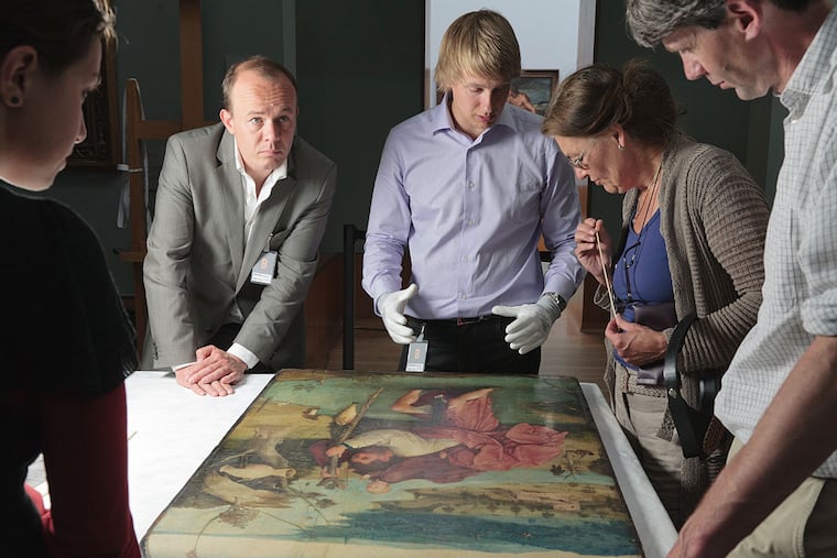 "Hieronymus Bosch: Touched by the Devil" follows a team - including art historian Matthijs Ilsink (rear left) and conservator Luuk Hoogstede - mounting a show for the 500th anniversary of Bosch's death.