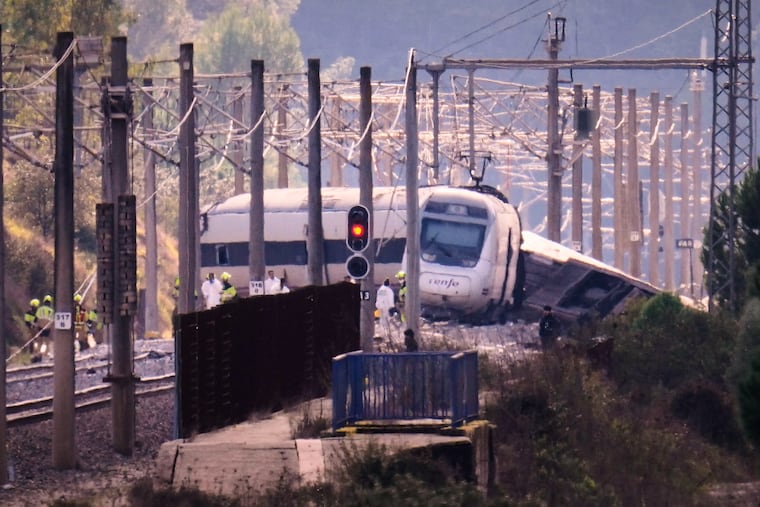Emergency crews work at the site of a train collision in Adamuz, southern Spain, Monday, Jan. 19, 2026.