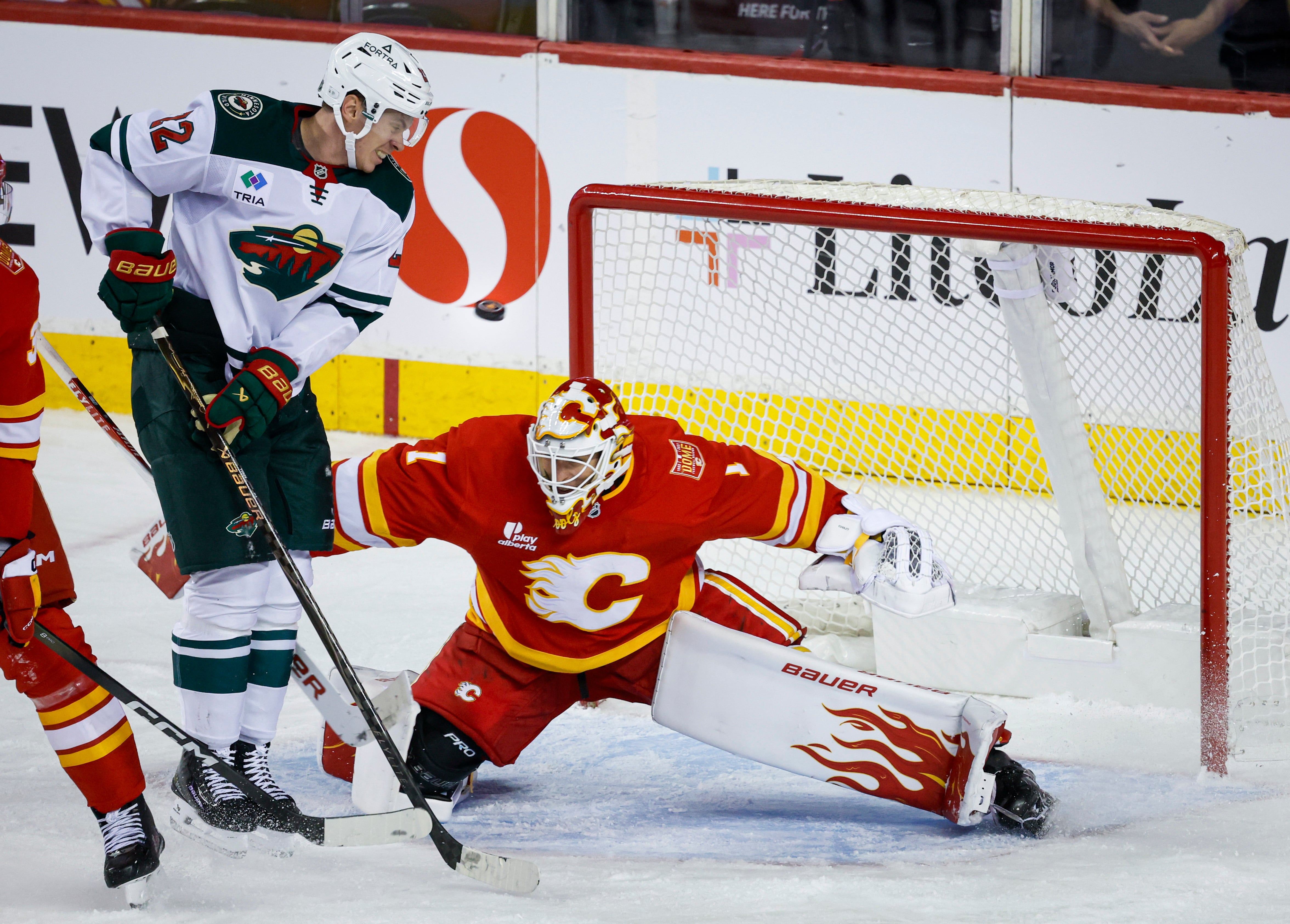 Cooley makes 36 saves in the Flames' 2-1 victory over the Wild
