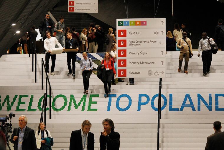 People walks down the stairs inside the venue of the COP24 U.N. Climate Change Conference 2018 in Katowice, Poland, Tuesday, Dec. 4, 2018. The two-week meeting brings together diplomats and interested pressure groups from almost 200 countries to discuss the 2015 Paris Accord and other climate issues. (AP Photo/Czarek Sokolowski)