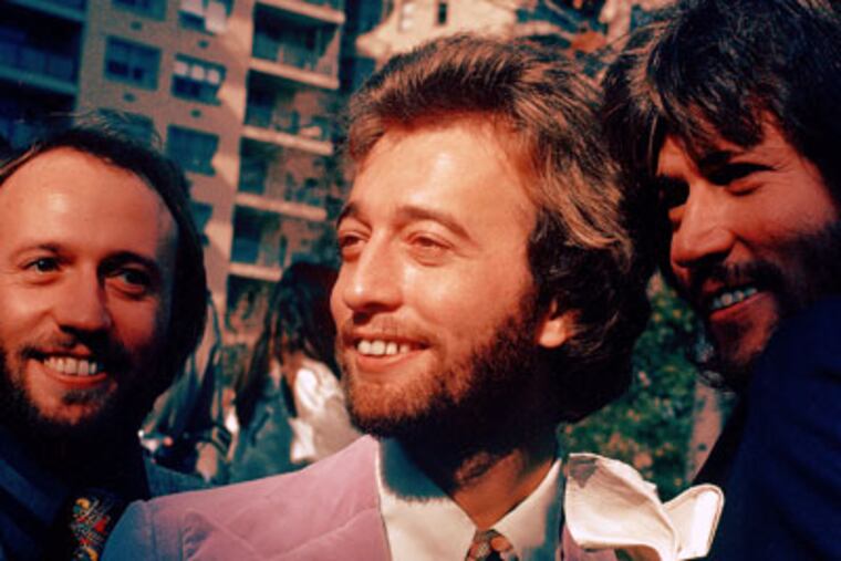 FILE- In this undated file photo, from left, members of The Bee Gees Musical Group, Maurice Gibb, Robin Gibb, Barry Gibb pose for a photo. A representative said on Sunday, May 20, 2012, that Gibb died at the age of 62. (AP Photo)