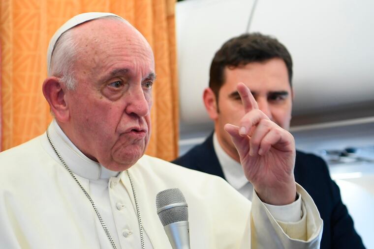 Pope Francis talks to reporters on a flight back to Rome on Tuesday.