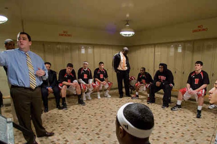 Rutgers-Camden coach Brian Wischusen talks to his players in the locker room at Gloucester County College in Deptford, their temporary home during renovations to their gym. Some on the team must commute through three counties on most days.