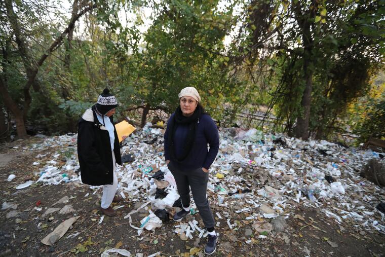 Charito Morales and Asteria Vives, under 2nd and Indiana streets, stand amidst trash, mostly water bottles and used needle wrappers.