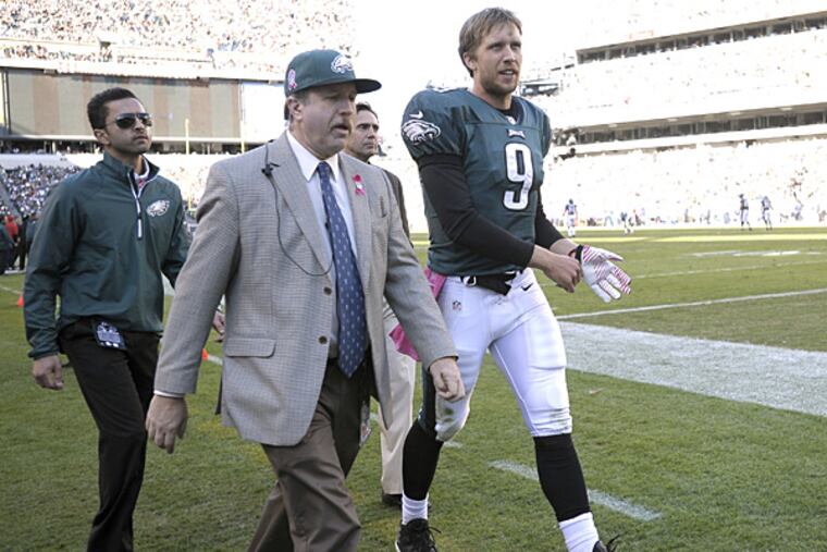 Philadelphia Eagles quarterback Nick Foles leaves the field for examination during the second half against the Cowboys. (Michael Perez/AP)