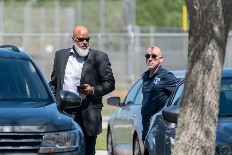 MLB Players Association executive director Tony Clark, left, and chief negotiator Bruce Meyer arrive for a collective bargaining session Wednesday at Roger Dean Stadium in Jupiter, Fla.