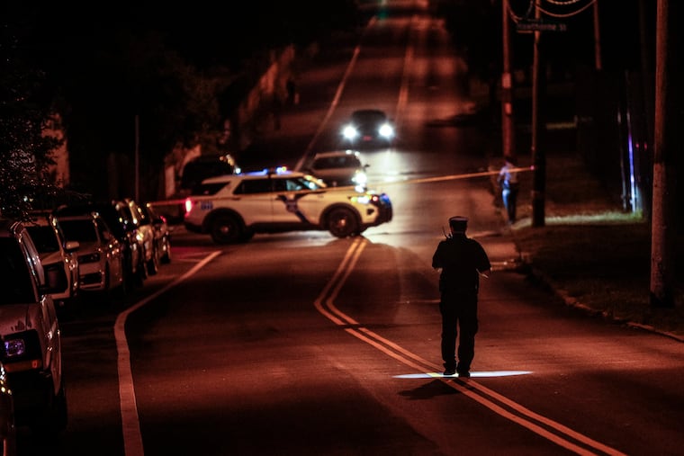 Police at Cheltenham Avenue and Charles Street where a Philadelphia highway patrol officer was injured during a car stop. Police look for clues on the stretch of Cheltenham Avenue, Monday, July 10, 2023.