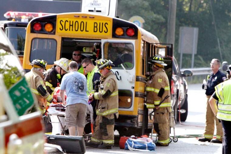Emergency officials aid victims of a multi-vehicle crash that occured on the Black Horse Pike where Chews Landing Road and Front Street all come together just north of the Big Timber Creek in the Glendora section of Gloucester Twp. on September 11, 2013. ( ELIZABETH ROBERTSON / Staff Photographer )