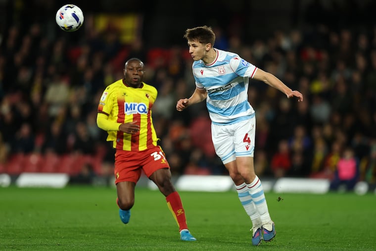 Max Cleworth (right) in action for Wrexham in March.