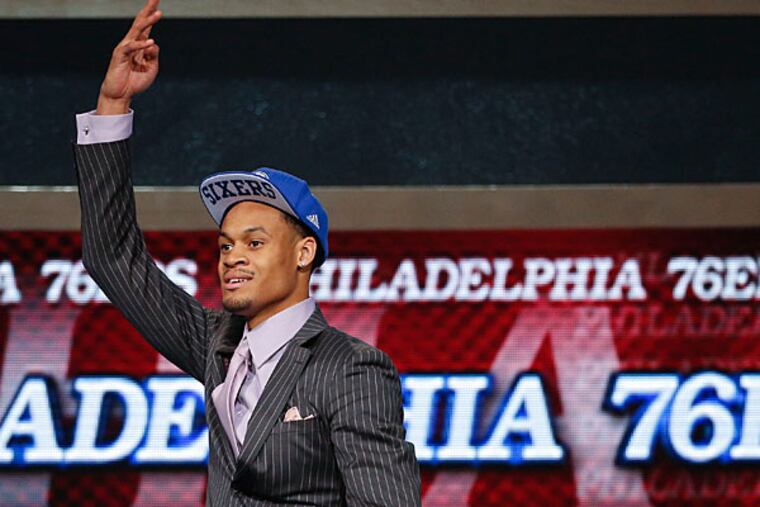 Clemson forward K.J. McDaniels motions to fans after being selected 32nd overall by the Philadelphia 76ers in the second round of the 2014 NBA draft, Thursday, June 26, 2014, in New York. (Jason DeCrow/AP)