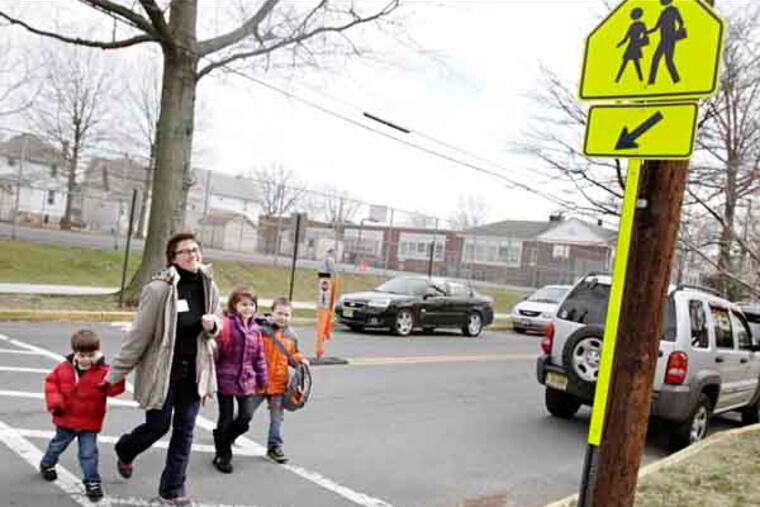 (L-R) Preschooler Frankie Castle, 4, Kelly Castle (mom), second grader Maureen Castle, 7 and kindergartner Henry Castle, 6, walk home from the Mark Newbie Elementary School in Collingswood on March 15, 2013. ( ELIZABETH ROBERTSON / Staff Photographer )