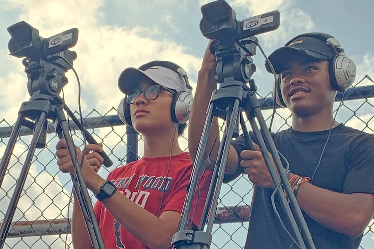 Penn Wood seniors Jimmy Sek and Chris Jones work cameras during production of a preseason Penn Wood football game in August for The Sports Fanbase Network.