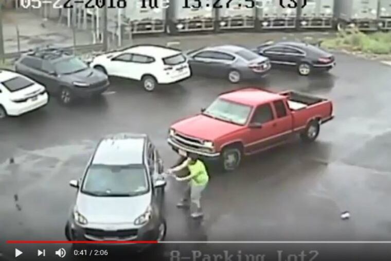 In a screengrab from surveillance video, the driver of a red pickup truck attacks a silver SUV with a sledgehammer about 1:30 p.m. Tuesday, May 22, 2018, on the 2700 block of East Luzerne Street in Port Richmond.