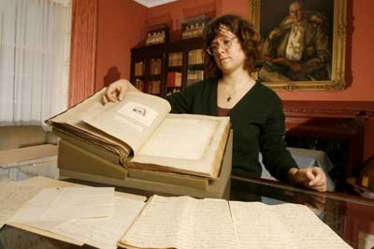 Farrar Fitzgerald, education coordinator at the Rosenbach Museum, looks over some of the love letters on display, including a letter from William Shakespeare to Anne Hathaway that was determined to be fake. (Charles Fox / Staff Photographer)