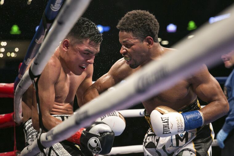 Shawn Porter, right, pushes Adrian Granados against the ropes during the WBC silver welterweight fight back in November.