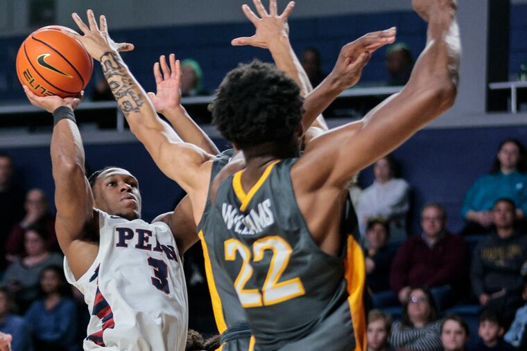 Penn’s Jordan Dingle shoots over Drexel’s Amari Williams during the first half at the Daskalakis Athletic Center.