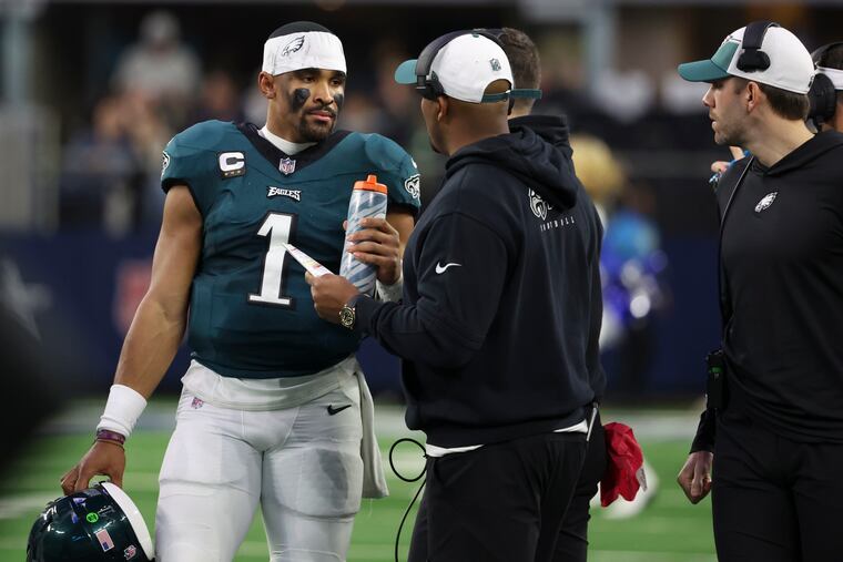 Eagles quarterback Jalen Hurts talks to offensive coordinator Brian Johnson as the first quarter ends against the Cowboys at AT&T Stadium on Sunday, Dec. 10, 2023, in Arlington, TX.
