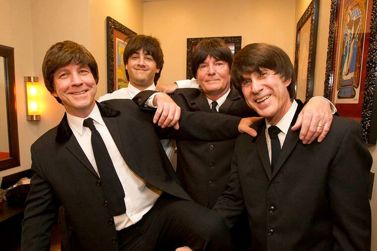James Cuorato (right) and (from left) Jim Miller as Paul, Chris Colon as George, and Mark McCloskey as John, clown around in the classic Beatles manner in a dressing room at the Hard Rock Cafe. (CHARLES FOX / Staff Photographer)