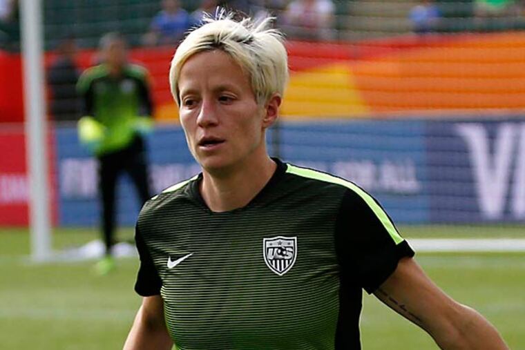 United States midfielder Megan Rapinoe (15) and forward Abby Wambach (20) high five during warm ups before the game against the Colombia in the round of sixteen in the FIFA 2015 women's World Cup soccer tournament at Commonwealth Stadium. (Michael Chow/USA Today)