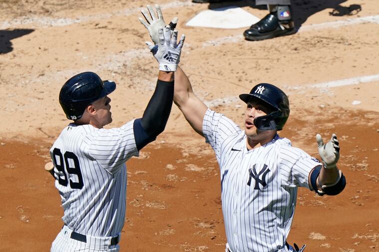Aaron Judge (99) celebrated with Yankees teammate Giancarlo Stanton after Stanton hit a solo home run against the Houston Astros in May.