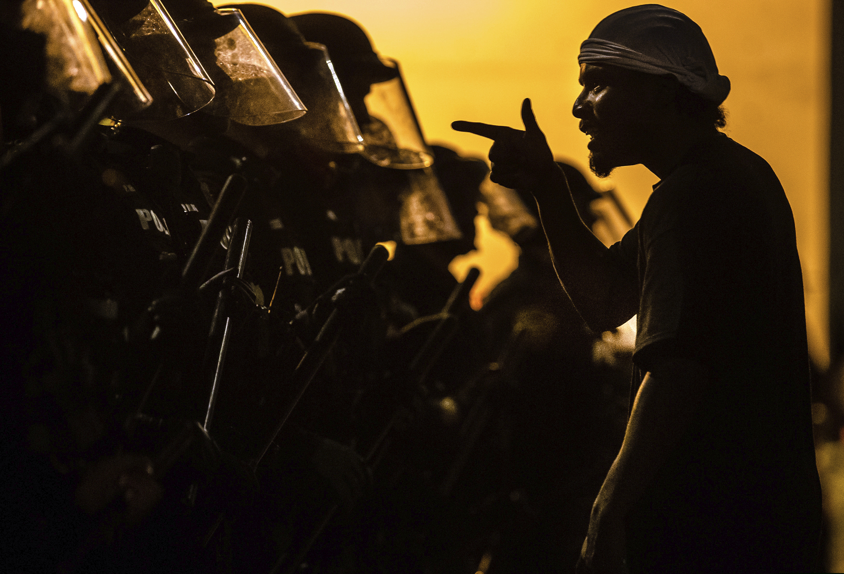 A protester vents at a line of Tucson Police Officers in riot gear at Cushing Street and Church Avenue early on Saturday, May 30, 2020 in Tucson. The protest in Tucson was similar to those in numerous cities across the United States following George Floyd's death while in custody of the Minneapolis police on Memorial Day in Minnesota. (Josh Galemore/Arizona Daily Star via AP)